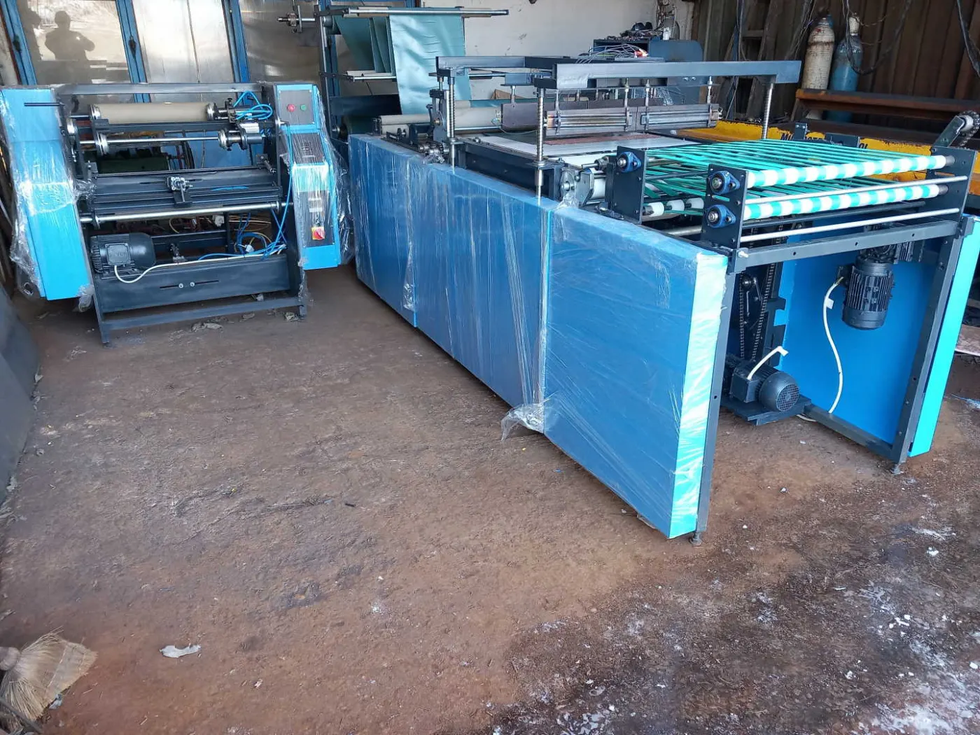 Film rewinder with finished film rolls beside the machine